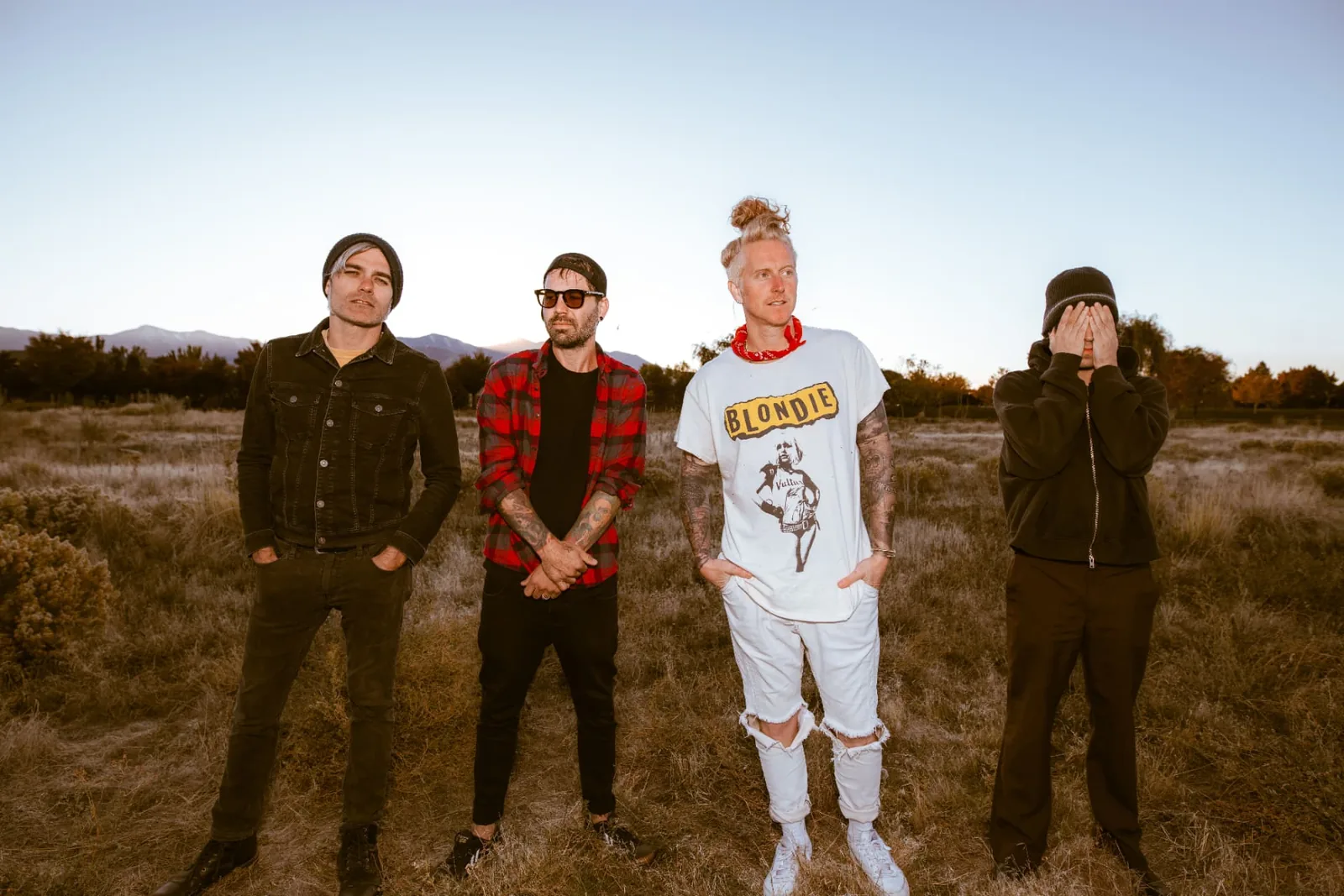 Members of We The Kings standing together outdoors